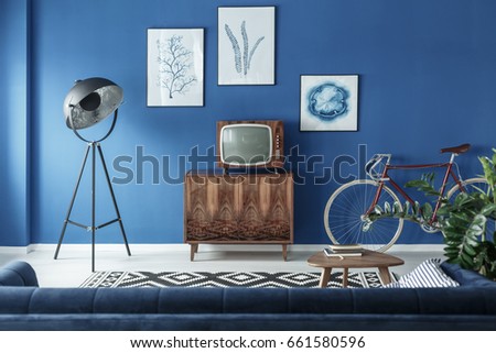 Vintage TV, bike and retro lamp in modern living room