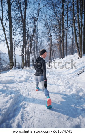 Woman running and training in winter