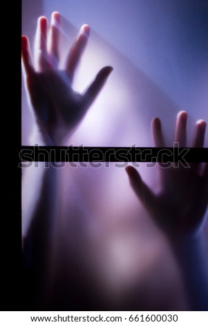 Blurred Pair of Hands through a Frosted Glass Window