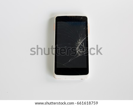 Broken mobile phone screen on white background