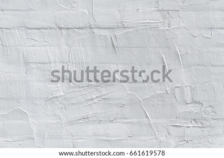 Thin layer of plaster on a brick wall. White plaster wall texture. Empty background