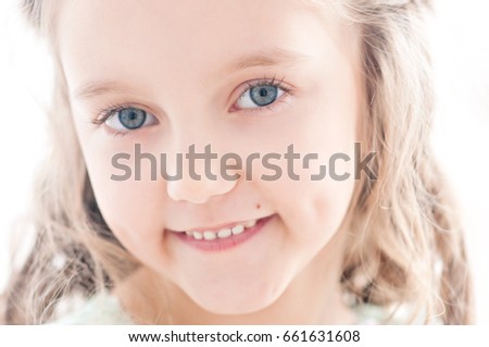 Beautiful little girl in mint dress celebrates her birthday