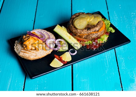 beef Burger and vegetables on a blue wooden table