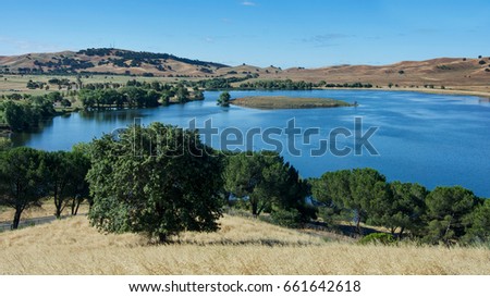 Panoramic view of the Lagoon Valley Park in Vacaville, California, USA, featuring the chaparral in the spring, with golden grass, and the lake Royalty-Free Stock Photo #661642618