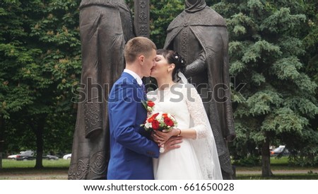 Bride and groom in a park kissing.couple newlyweds bride and groom at a wedding in nature green forest are kissing photo portrait.Wedding Couple.