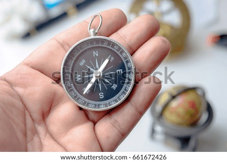 Vintage compass in hand