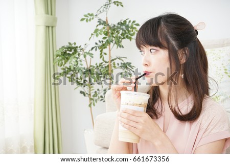Young woman drinking coffee at room