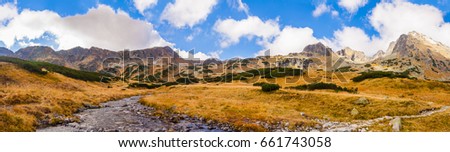 Mountain panorama - Stream flowing through the valley with golden autumn colors of Poland.