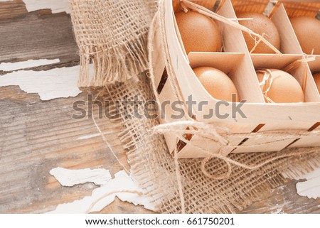 Chicken eggs on a wooden rustic background 