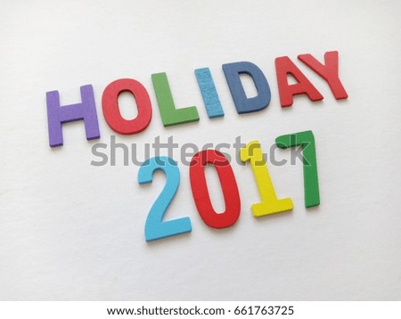 wooden blocks text holiday 2017 concept and colorfull alphabet . underexposed 