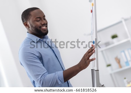 Happy nice man looking at the whiteboard
