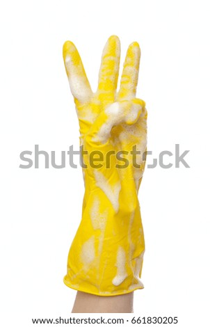 Hand in yellow glove three fingers up soap foam white background