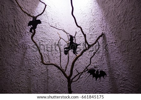 Silhouette of the witch and the ghosts hanging on the black tree