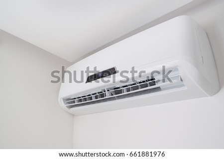 White split air conditioner closeup on a white wall. Home interior in a small apartment
