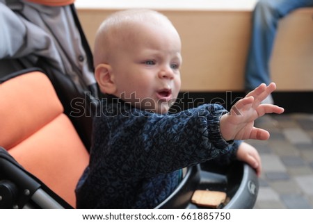 The child makes a gesture with his hand no
