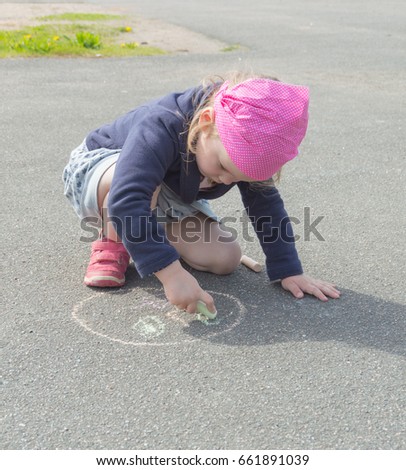 chalk on asphalt draw a circle baby girl.