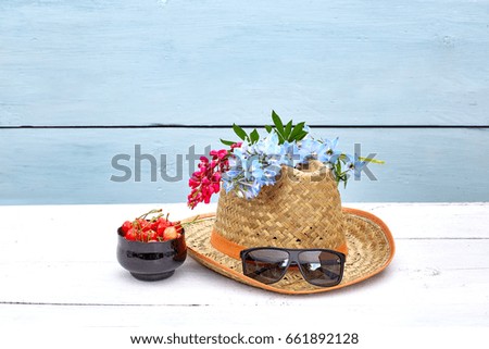 Summer concept with hat, flowers and dark glasses