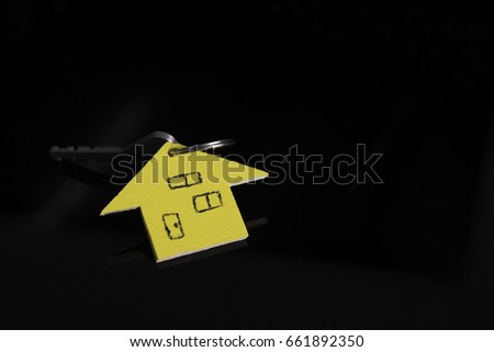 house key on black background, real estate agent concept