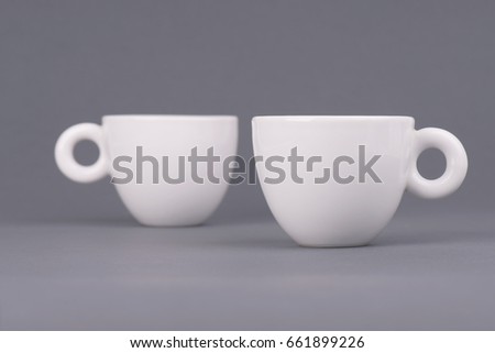 Two white coffee cup on grey background. Design template for Mock Up