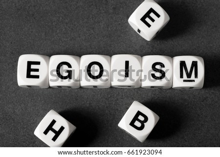 word egoism on white toy cubes Royalty-Free Stock Photo #661923094