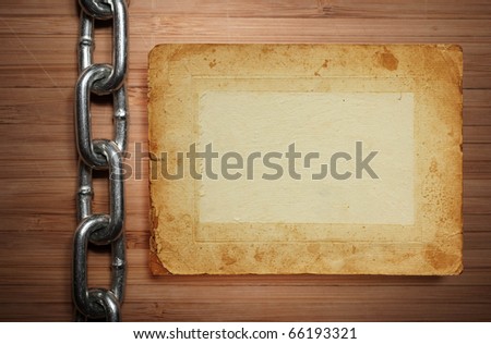 a old paper on wooden desks with chain as a background or texture on white