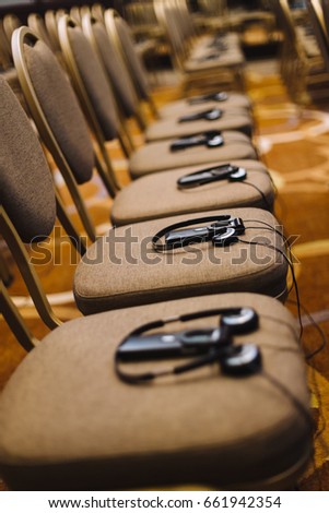 Translation headphones on a chair in a conference room
