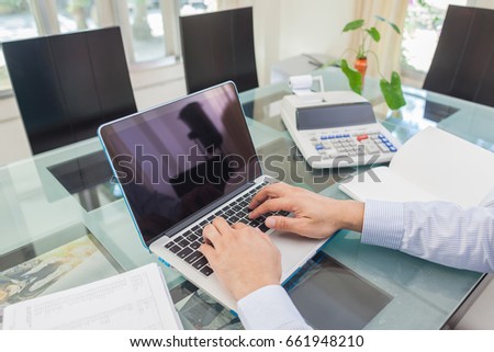 Business man pointing on analysis graph in laptop monitor during working at home