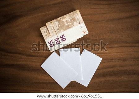Bank cards, business cards, cash money on a wooden background, texture