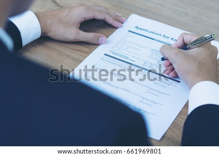 Businessman fill in Employment Application form concept with a pen 