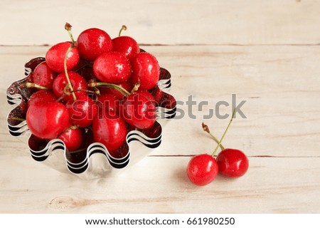 Red ripe juicy sweet cherry lies on vintage wooden background. Sweet summer berries. Flat lay, top view. Copyspace, healthy food.