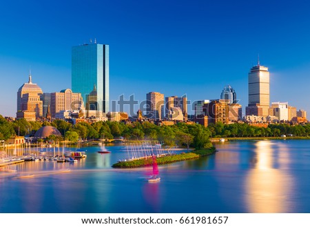 Boston skyline at the evening. Cityscape of Back Bay Boston. Skyscrapers and office buildings reflected in the water of Charles River.