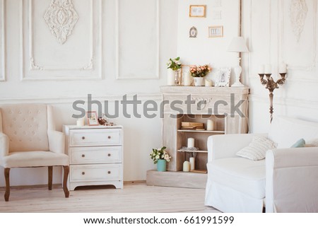 Room with a light interior and white furniture items