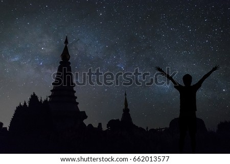 Man happy success seeing Milky way over the two pagodas, the landmark of Doi Inthanon at Chiang Mai, Thailand.