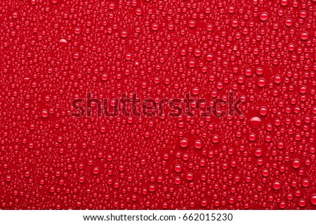 Water drops on a red background Royalty-Free Stock Photo #662015230