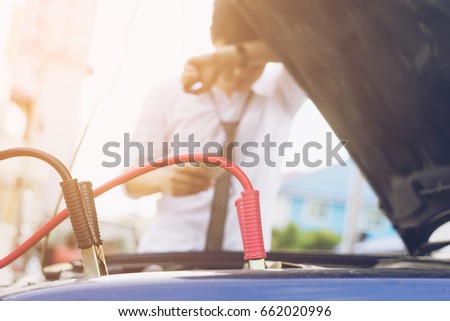 Blurred of sad man looking at his broken car