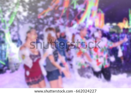 blur people in neon party foam in the Songkran festival Thailand 