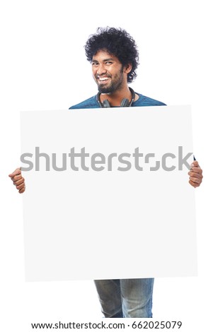 Happy young man holding whiteboard.