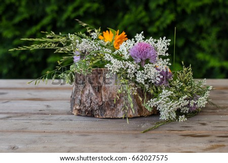 Wreath from  flowers on wooden background. Midsummer in Latvia. Celebration of Ligo feast in June Royalty-Free Stock Photo #662027575