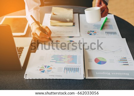 Businessman investment consultant analyzing company annual financial report balance statement working with documents graphics. Concept picture of economy,project, market, office,money and tax. Royalty-Free Stock Photo #662033056