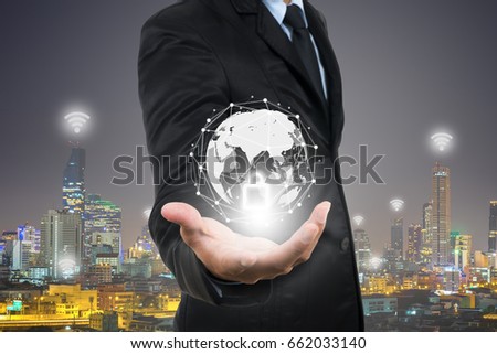 Smart businessman holding digital network security block-chain Smart city and wireless communication network, digital connecting world visual, internet of things (IoT) and Digital era. Marketing 4.0