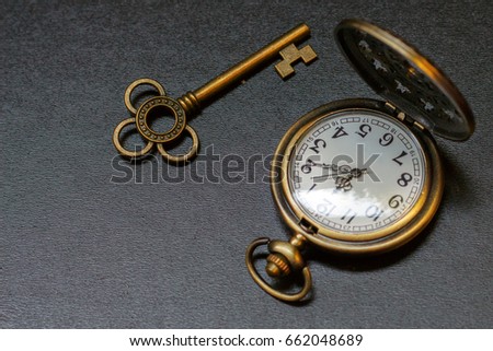 pocket watch and old key. Vintage Wonderland background