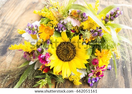 Fresh Bouquet of Summer Flowers on a Rustic Wooden Background.