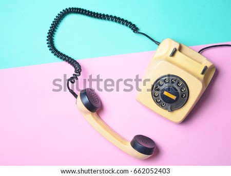 Vintage phone on a blue pink  pastel table. Pop colors. Communication 80s. Flat lay. Royalty-Free Stock Photo #662052403