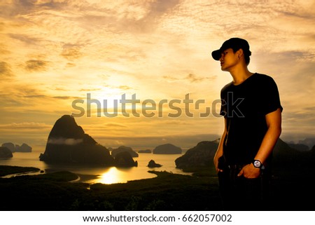 Silhouette of young man on sunset or sunrise, High contrast and partial silhouette picture