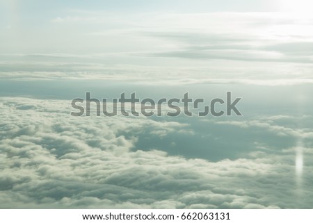 Higher than clouds background. View from airplane on lower and higher layer of clouds and sky horizon in the morning. Aerial cloudscape. High angle view from the plane, bird eye view, Aerial view