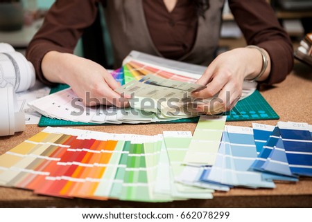 Close up architect with color palette on her desk. Working on new architect and design plan. Professional architecture blueprints