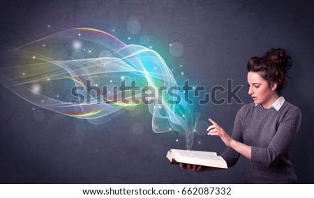 Casual young woman holding book with rainbow waves flying out of it