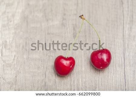 Red cherries on a wooden background. Top view