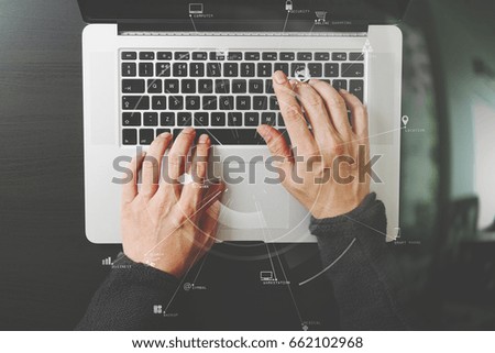 top view of businessman typing keyboard with laptop computer on wooden desk in modern office with virtual reality icon diagram   