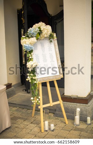 Frame with guests' settlement stands on the easel before the entrance